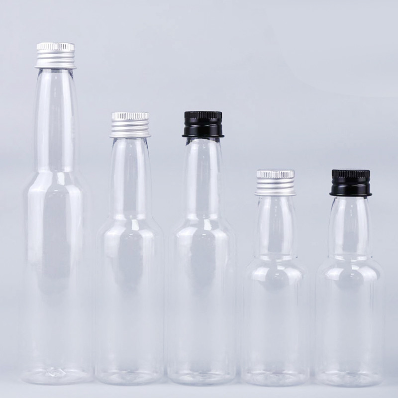 गर्म बिक्री 50ml पारदर्शी गोल प्लास्टिक पीईटी एल्यूमीनियम ढक्कन के साथ शराब की बोतल