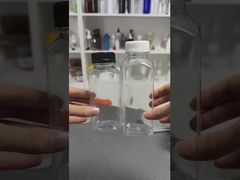 प्लास्टिक की जूस की बोतलें कैप के साथ पेय के लिए ढक्कन के साथ स्पष्ट पेय कंटेनर